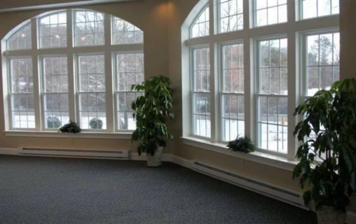Spacious room with large windows and natural light.