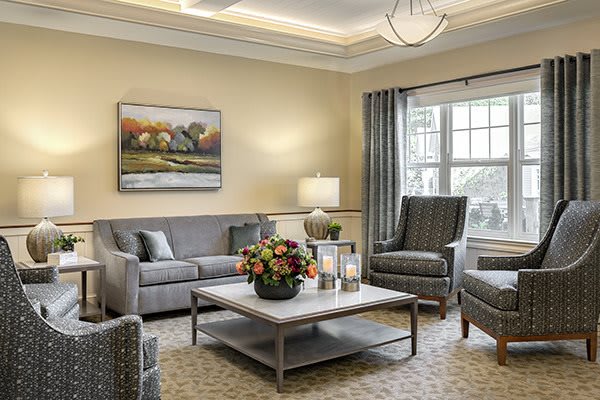 A cozy and elegantly designed living room with a neutral color palette, featuring comfortable seating and stylish decor.