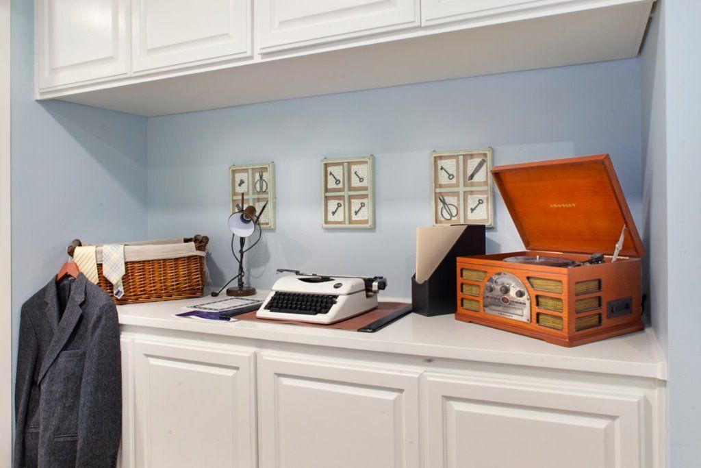 A home office with vintage decor featuring a typewriter and a record player.