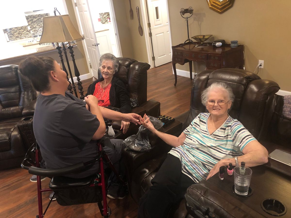 A group of people enjoying a conversation in a cozy living room setting.