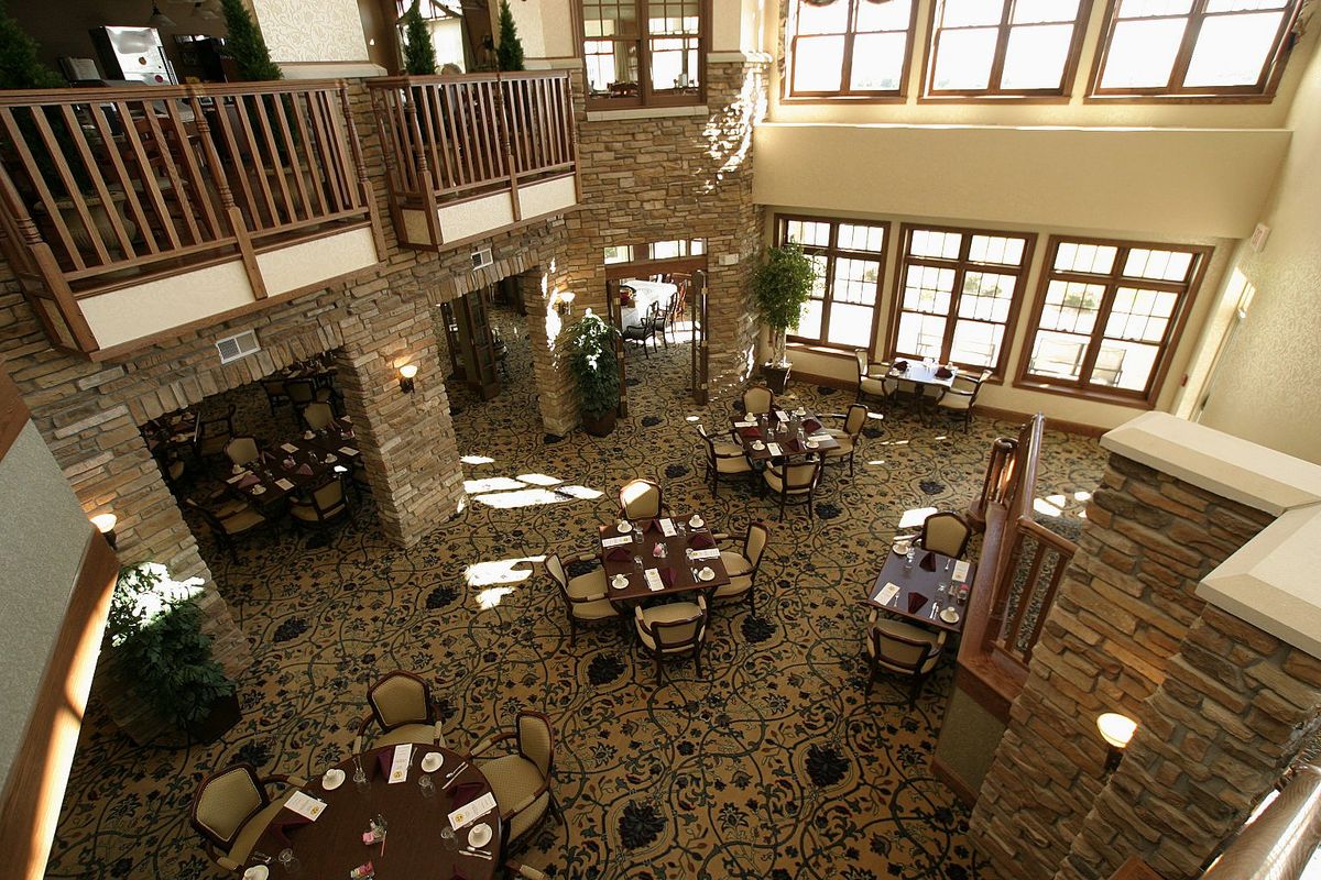 A spacious dining area with elegantly arranged tables and a warm interior design.