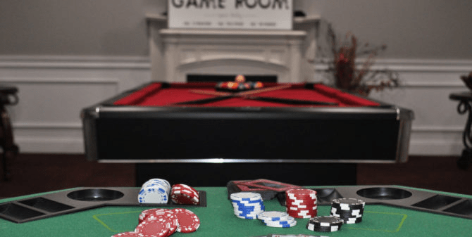 A game room featuring a pool table and poker chips ready for play.