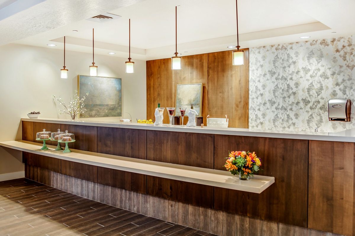 A modern hotel reception area with a stylish front desk and contemporary lighting.