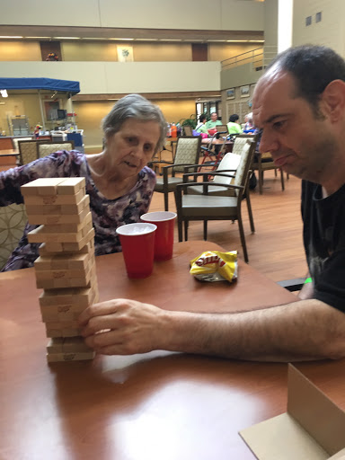A moment of concentration and fun as two individuals enjoy a game of Jenga together.