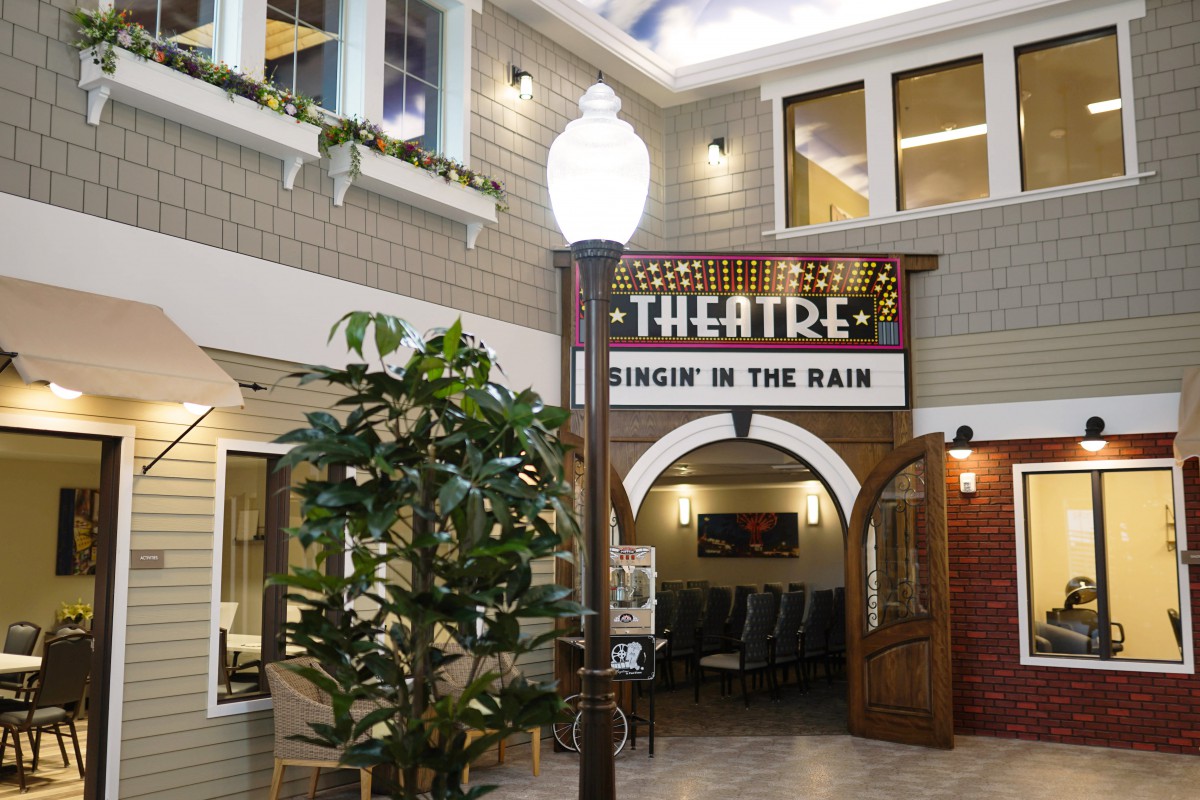 Indoor theatre entrance with vintage marquee sign and decorative elements.
