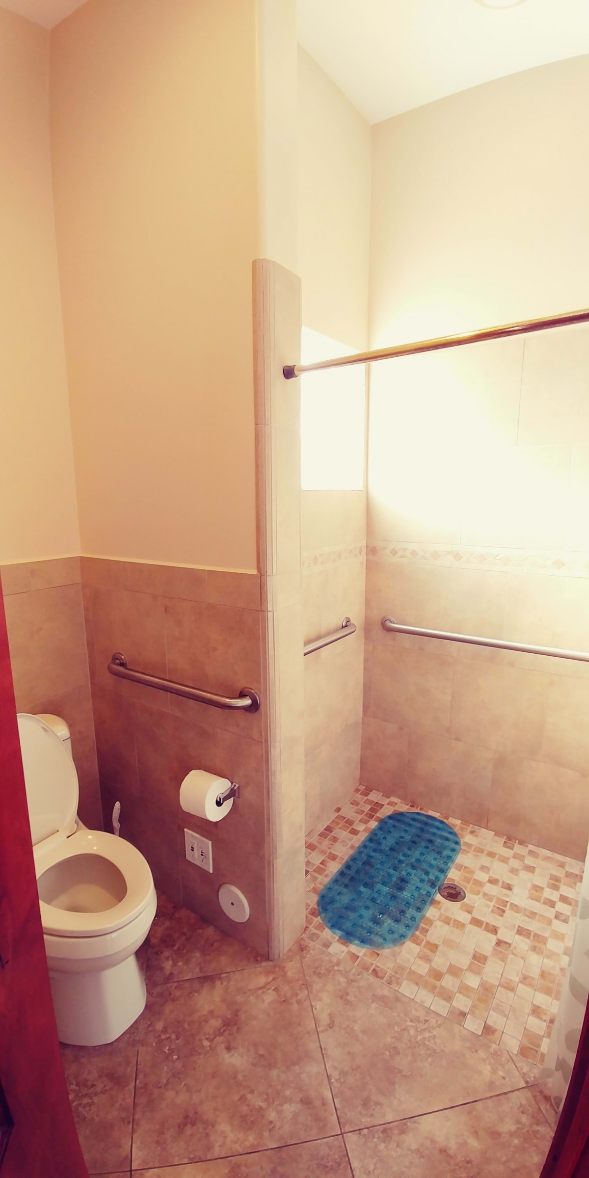 A clean bathroom with a toilet and walk-in shower.