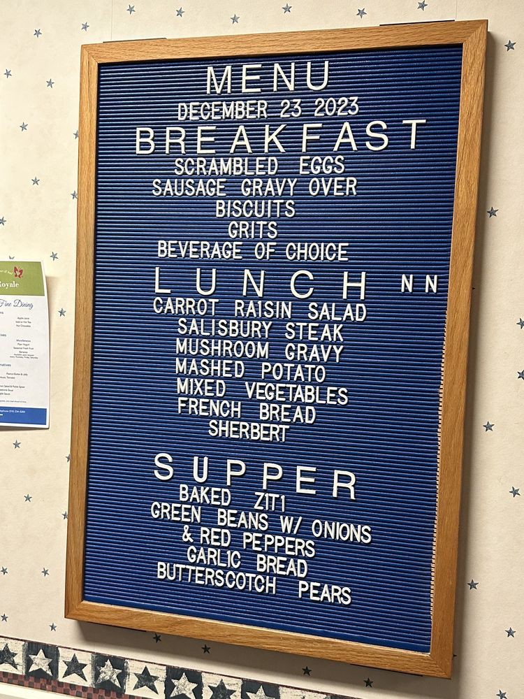 Menu board displaying meal options for December 23, 2023, including breakfast, lunch, and supper items.