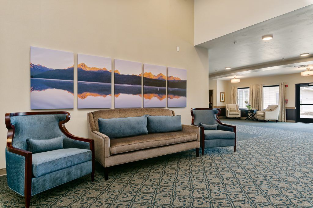 A spacious lobby with elegant seating and scenic artwork on the wall.