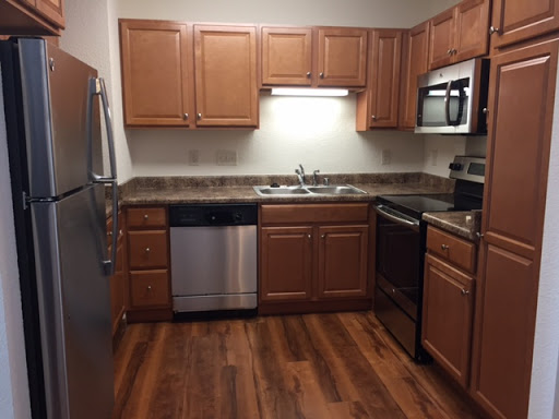 Modern kitchen with wooden cabinets and stainless steel appliances.