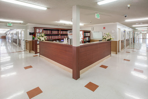 A welcoming reception area with wooden furniture and floral decorations.