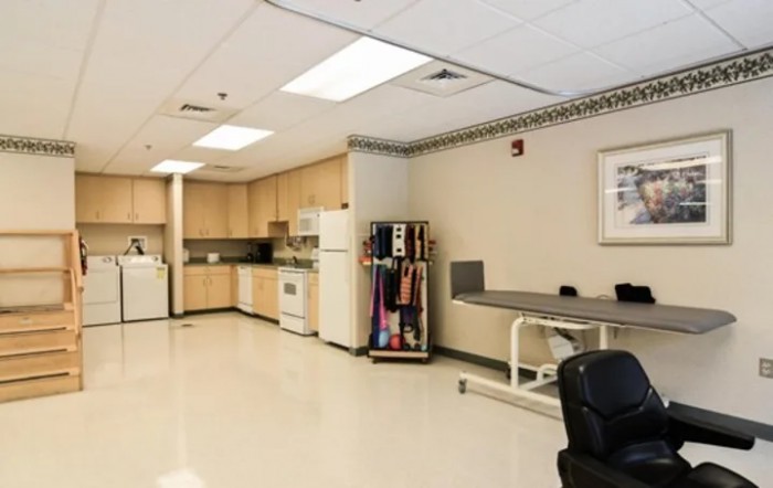 A clean and well-equipped medical clinic treatment room.