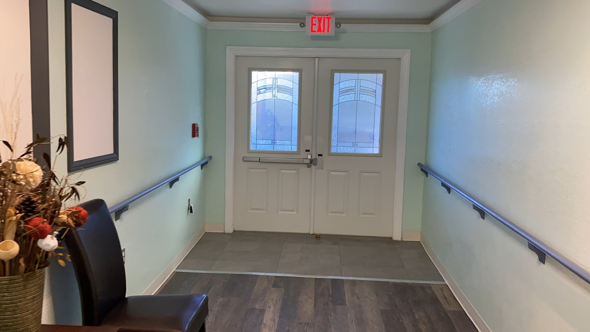 A hallway with double doors leading to an emergency exit.