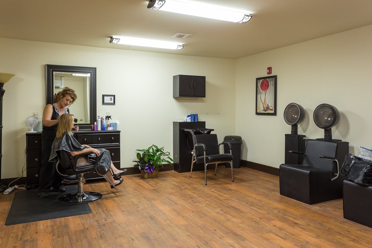 A hairstylist working in a salon with modern interior design.