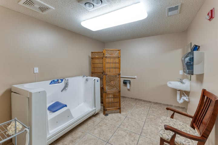 An accessible bathroom with a walk-in tub and safety features.