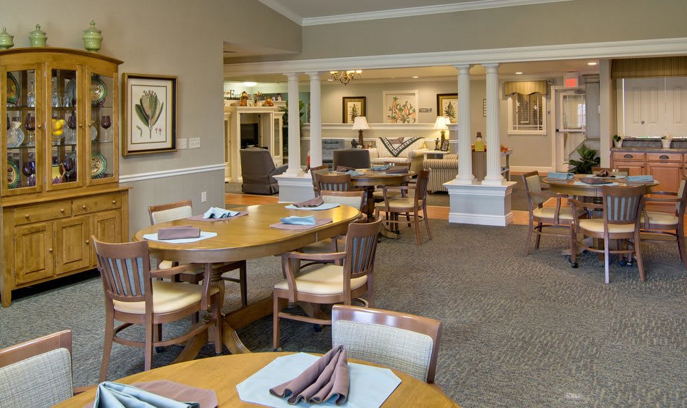 An elegant dining room interior featuring neatly arranged tables and chairs.