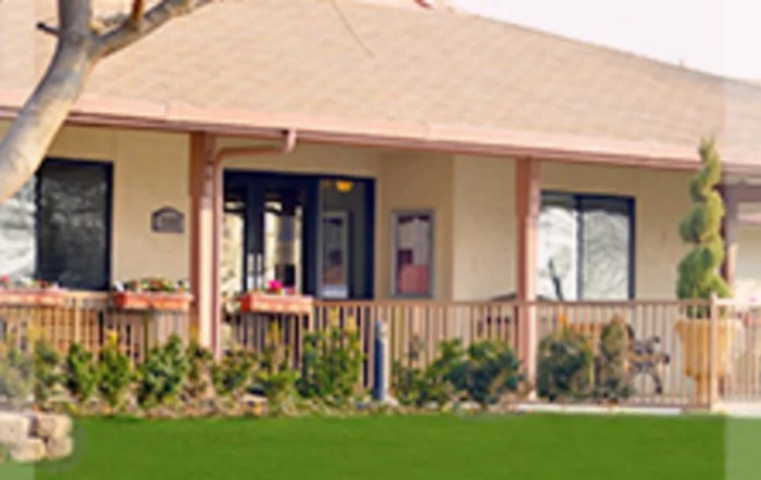 A small house with a porch and garden area.