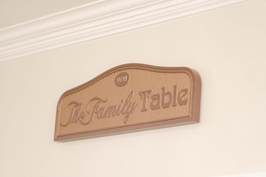 A decorative wooden sign on the wall reads 'The Family Table'.
