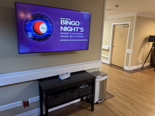 A promotional display for Bingo Nights in a community space, featuring a television screen and a welcoming interior.