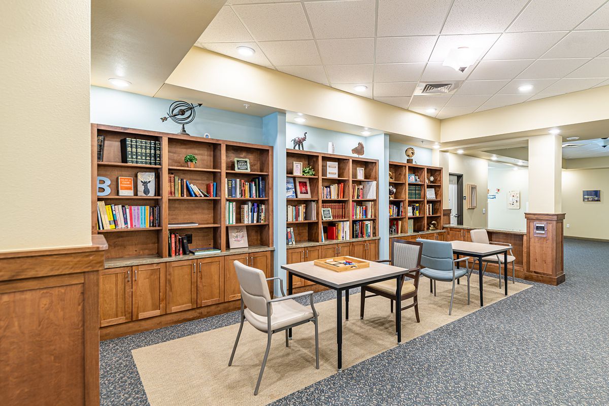 A library space with bookshelves and tables for reading.
