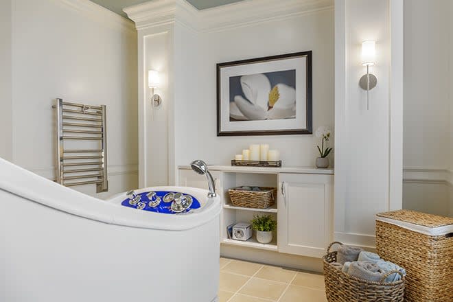 A modern bathroom featuring a luxurious bathtub, elegant decor, and soothing lighting.