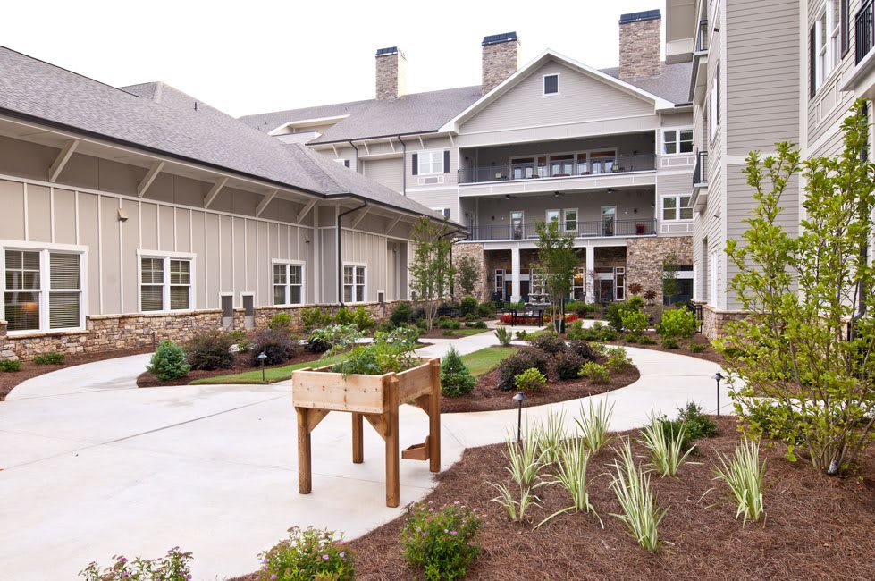 A well-maintained residential building with landscaped gardens and a winding pathway.