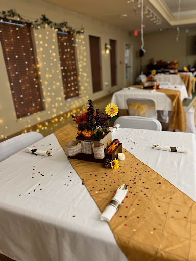 A beautifully arranged table setting featuring autumn-themed decorations and a centerpiece of flowers, perfect for an event or celebration.