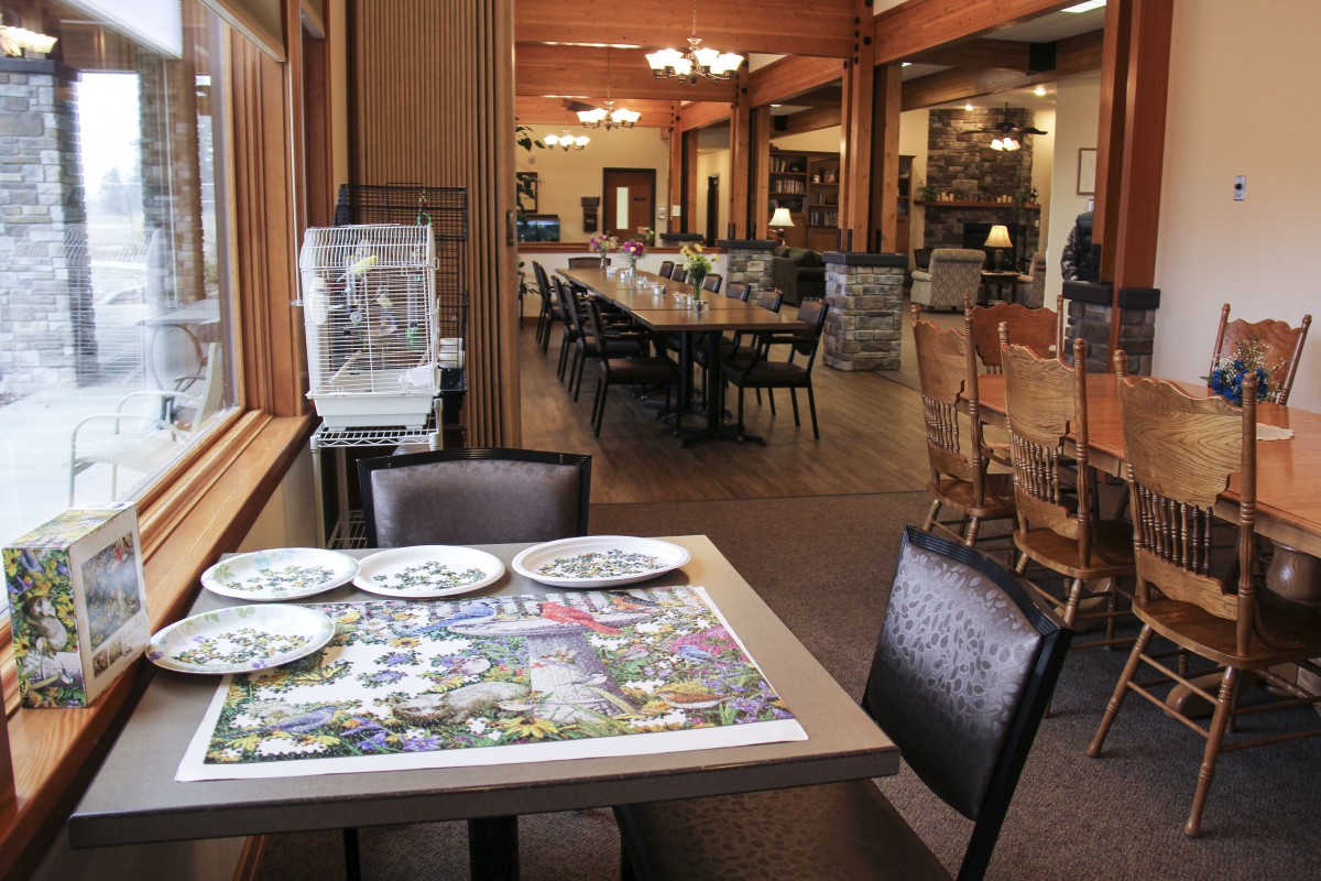 An empty restaurant dining area with neatly set tables and chairs.