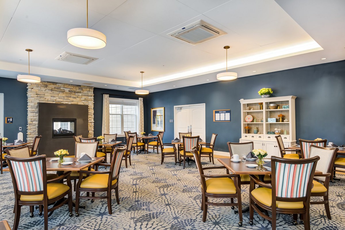 A well-furnished dining area with elegant chairs and tables, stylish lighting, and tasteful decor.