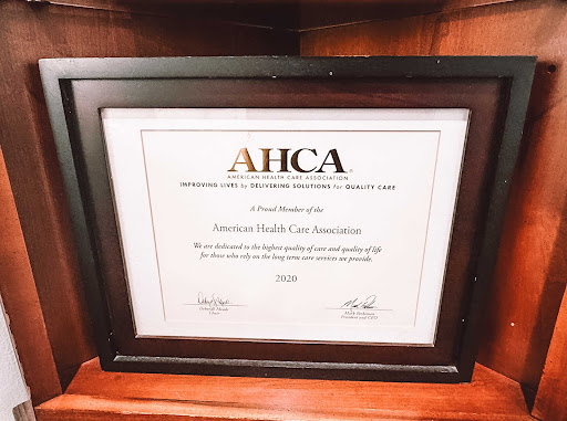 A framed certificate from AHCA, signifying an achievement.