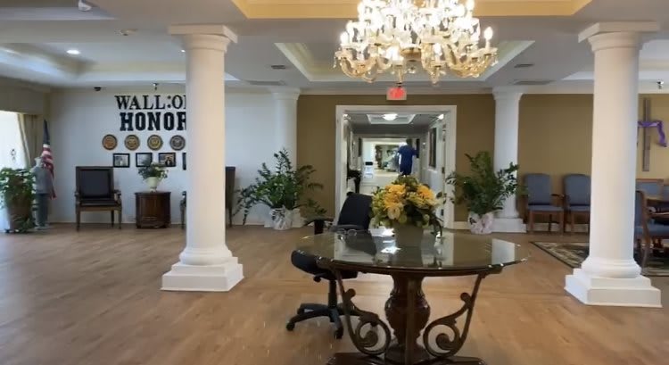 Elegant lobby area with a chandelier and decorative table centerpiece.