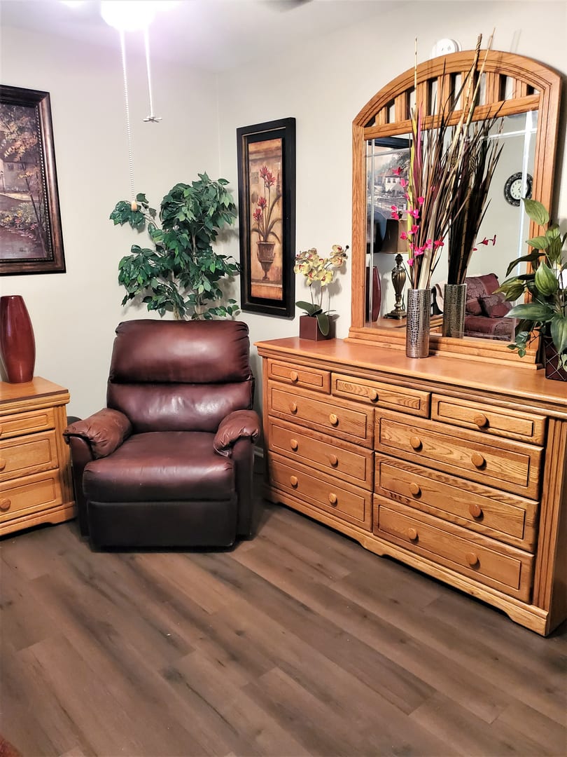 A cozy living room setup featuring wooden furniture and decor.