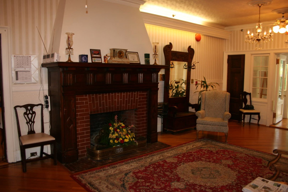 A cozy living room with a classic fireplace and elegant decor.