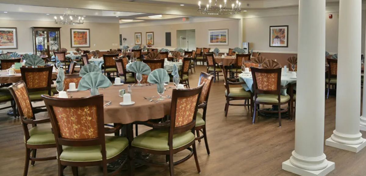 A spacious dining area with neatly arranged tables and elegant place settings.