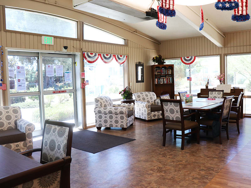 A cozy interior of a lounge area decorated with patriotic-themed banners and comfortable seating.