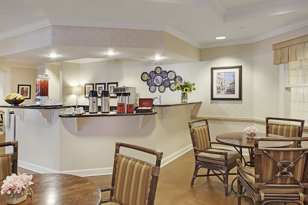 A cozy seating area with a coffee station and modern decor.