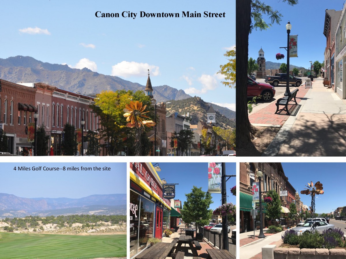 A picturesque view of Caon City's downtown main street with shops, benches, and scenic mountain backdrop.