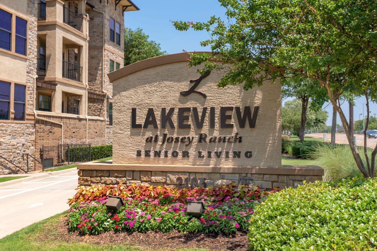 Entrance sign for Lakeview at Josey Ranch Senior Living surrounded by landscaping.