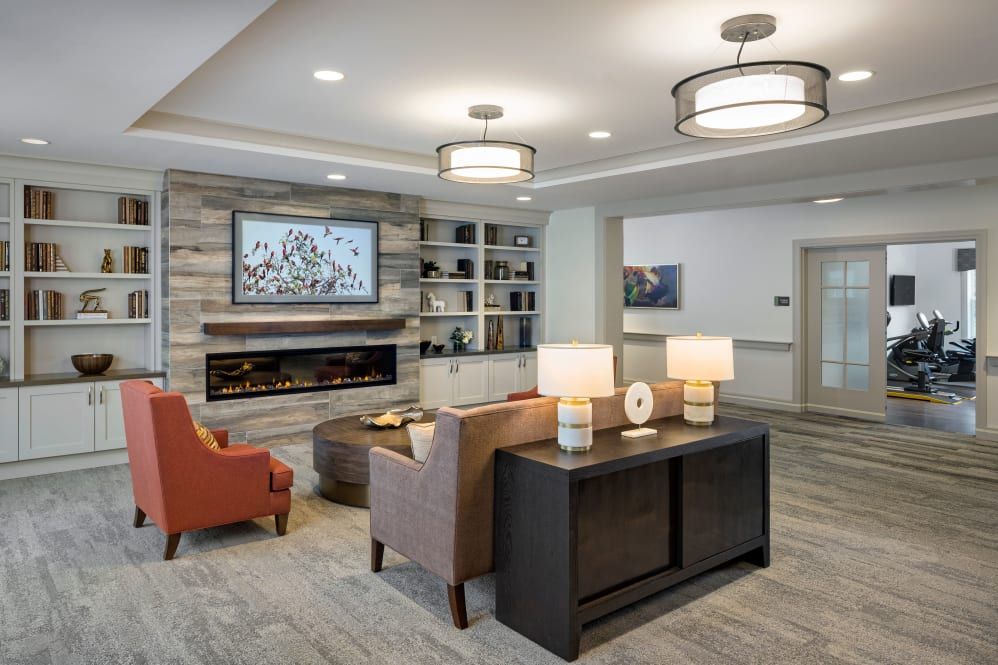 A modern living room with comfortable seating, a fireplace, and stylish decor.