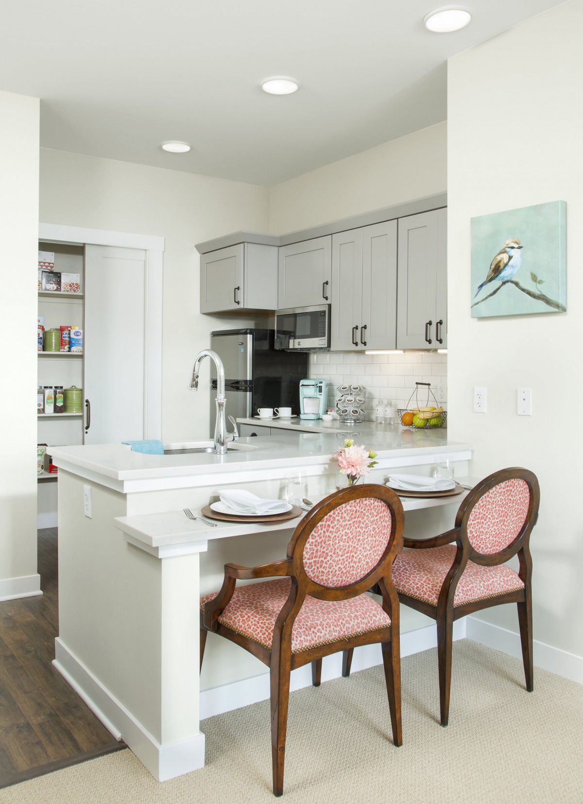 A modern kitchen interior with a dining counter and elegant chairs.