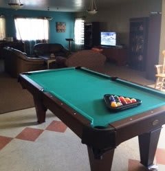 A cozy game room featuring a pool table and seating area.