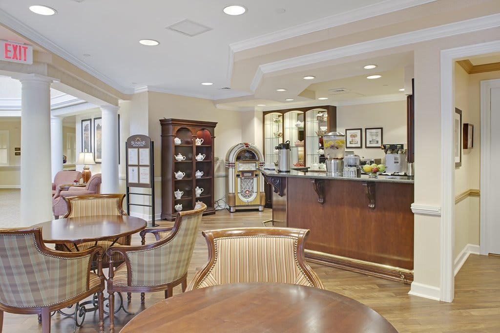 A cozy cafe interior with wooden furniture and a coffee station.
