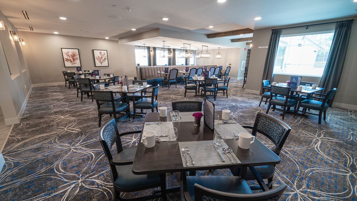 A quiet and neatly arranged restaurant dining area with tables set for service.