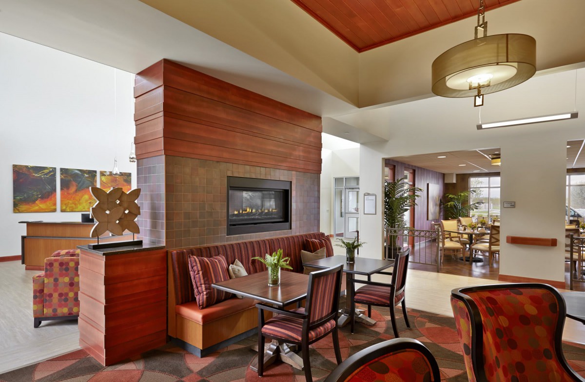 A modern dining area with a cozy fireplace and elegant seating arrangements.
