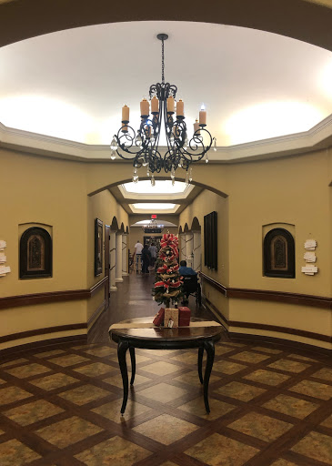 A beautifully decorated hallway featuring a chandelier and elegant furnishings.