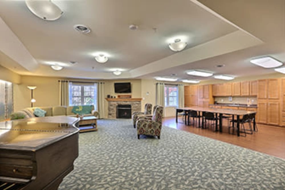 A spacious living room with comfortable seating, a fireplace, and a television.