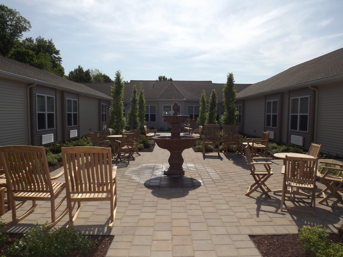 A serene courtyard with a central fountain surrounded by outdoor seating.