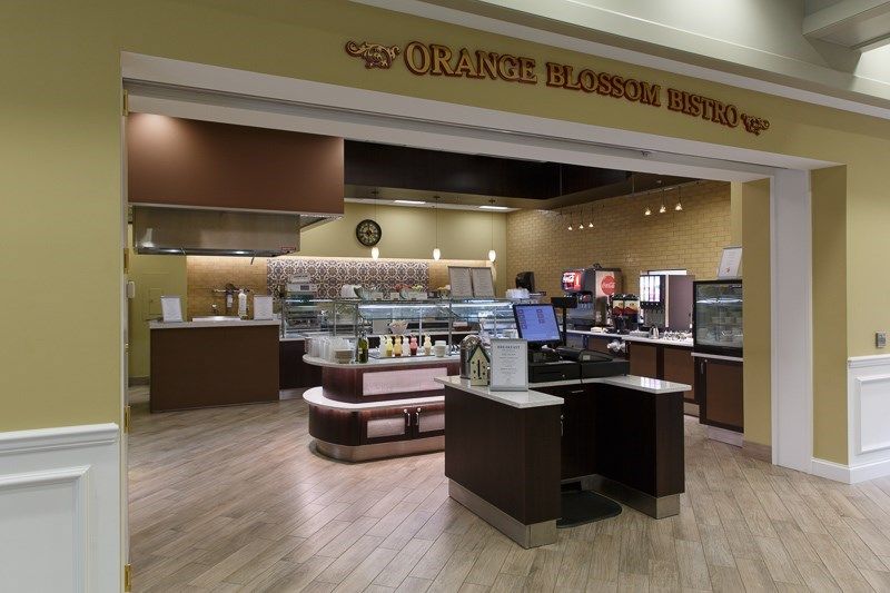 A cozy cafe with a well-organized counter and dessert display.