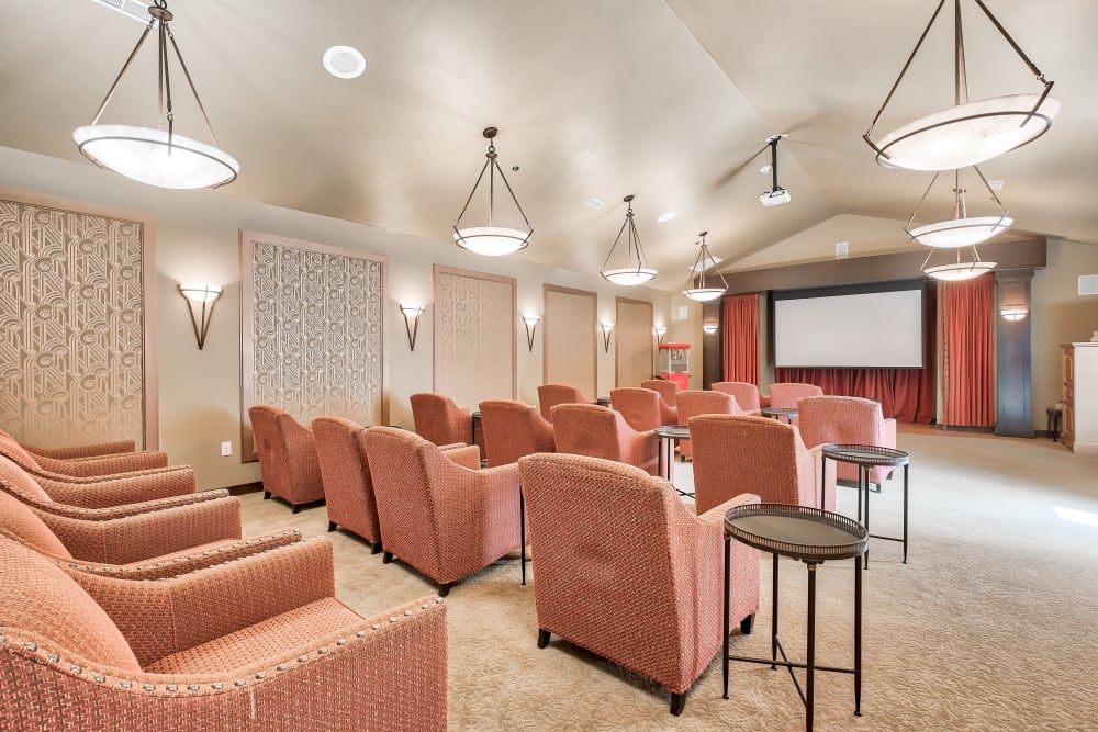 A cozy theater room with comfortable seating and a large screen.