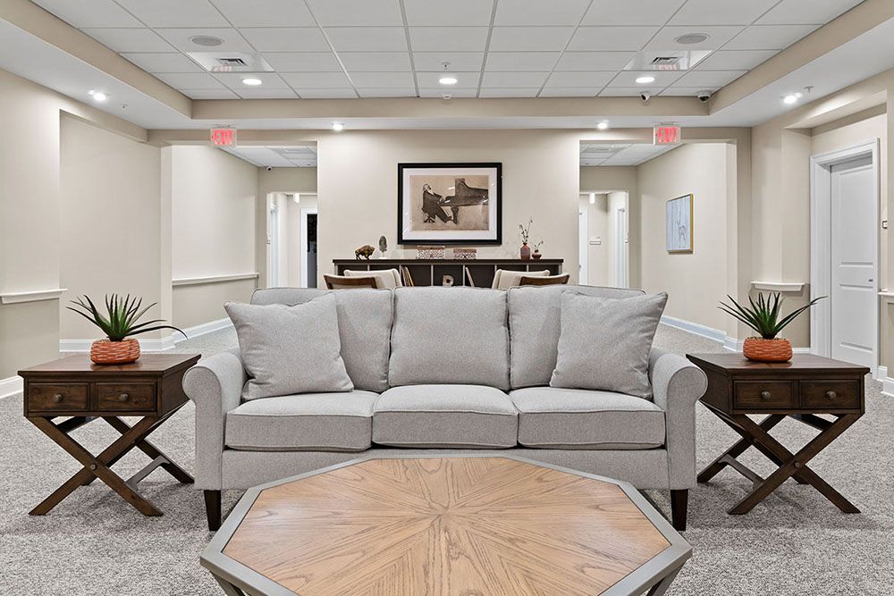 A cozy living room space featuring a comfortable sofa, a wooden coffee table, and elegant decor.