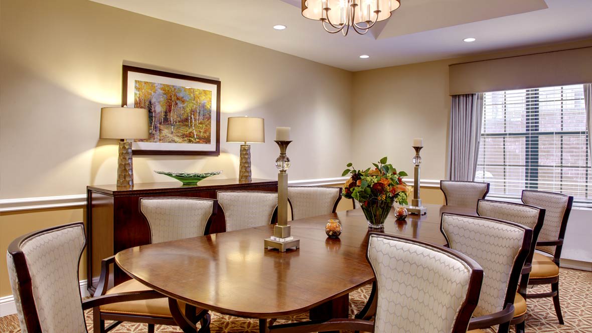 A cozy dining room with elegant furnishings and warm lighting.